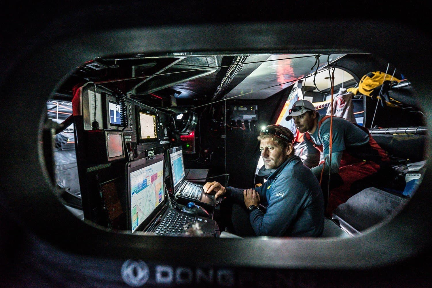 Navigator at the nav station aboard an offshore racing yacht
